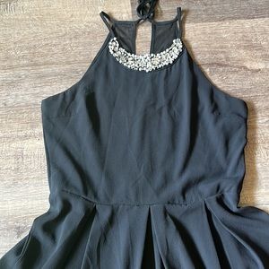 Teeze me black romper. Interior lining polyester exterior. Has a beaded neckline